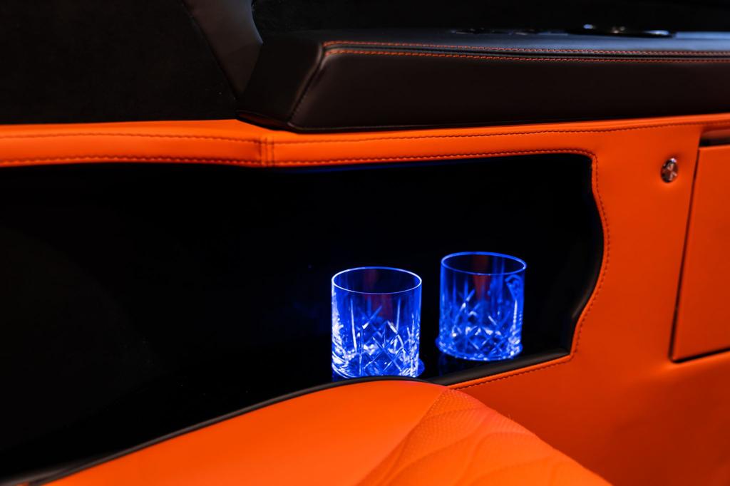 Luxury chauffeur vehicle interior with crystal glasses and premium leather trim, showcasing the first-class travel experience from All Stars Chauffeur in London and the UK.