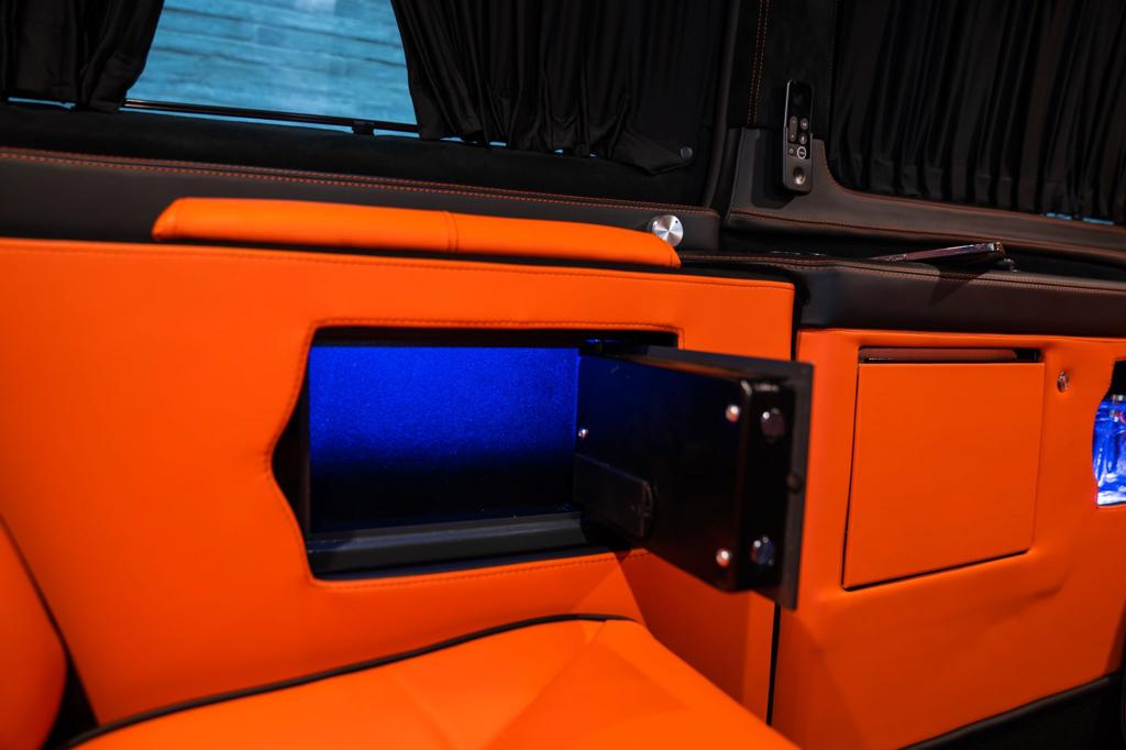 Luxury VIP chauffeur interior with illuminated storage compartment, premium leather trim and passenger amenities from All Stars Chauffeur in London and the UK.